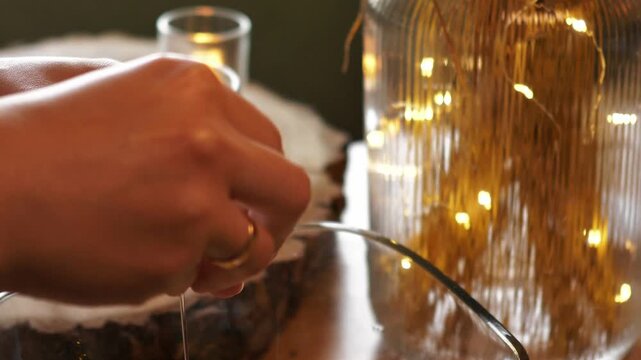 Macro of cracking a raw egg with a knife and separating egg yolk from egg white