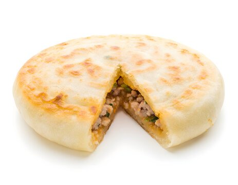 Northern Chinese xian bing stuffed meat pie, flat round golden pan-fri Isolated on White Background