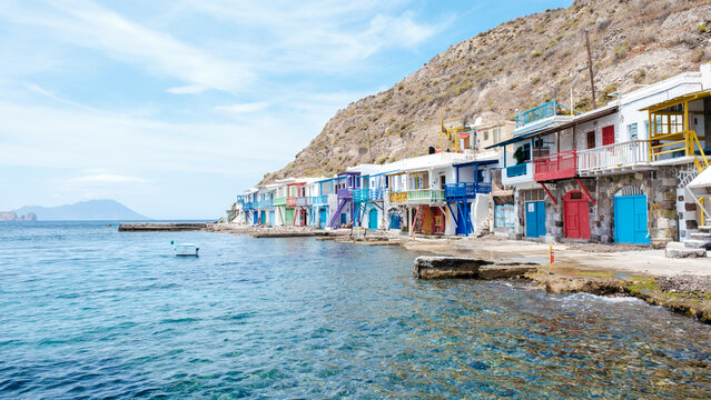 Colorful fishing houses by the sea in Klima, Milos, Greece framed by a stunning coastline
