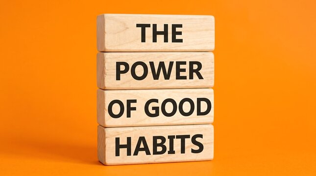 Wooden blocks with text the power of good habits concept, self improvement inspiration on orange background, personal development motivation