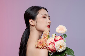 Elegant young woman with pastel flower bouquet in profile portrait © TuongThi