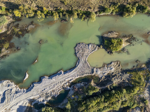 Aerial view of the Buna-Drin River Confluence showing the meeting of two rivers with distinct water colors, sandbanks, and surrounding lush vegetation in Zues, Qarku i Shkodres, Albania.