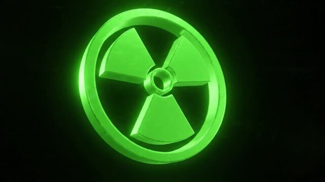 Glowing green nuclear radiation symbol on a dark background