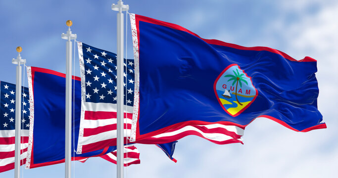 Flag of Guam waving in the wind with the US flag on a clear day