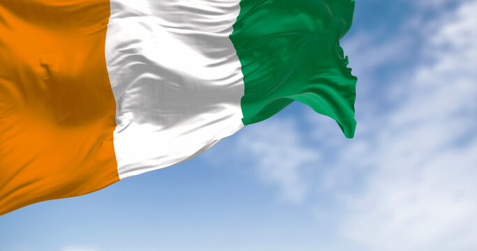 Ivory Coast national flag waving in the wind on a clear day