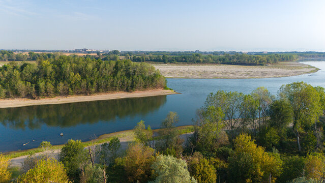 Aerial view of the Po River with low water levels and exposed sandy riverbed sediments due to summer drought, Castelvetro Piacentino, Emilia-Romagna, Italy.