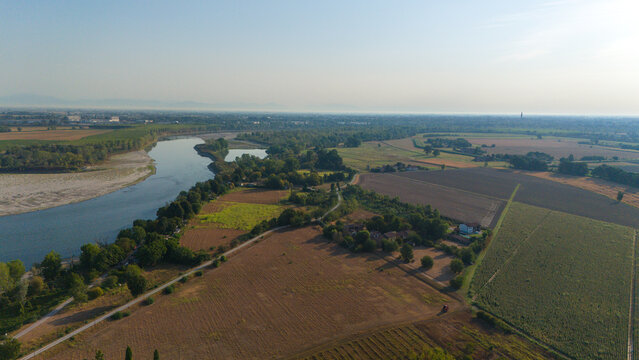 Aerial view of the Po River with low water levels due to drought and summer heatwave exposing riverbed sediments in Castelvetro Piacentino, Emilia-Romagna, Italy.