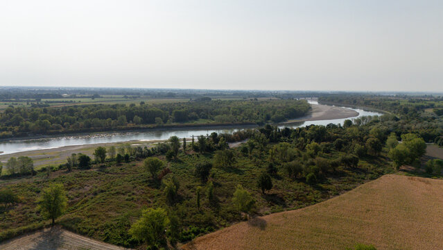Aerial view of the Po River with low water levels due to drought and summer heatwave exposing sediments and riverbed in Castelvetro Piacentino, Emilia-Romagna, Italy.