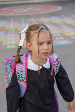 Beautiful small girl with blonde hair to her very first day of school