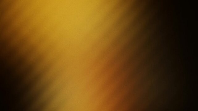 Abstract golden diagonal light rays. A warm blurred glowing light effect featuring smooth transitions and subtle motion creates a calm and sophisticated digital presentation overlay.