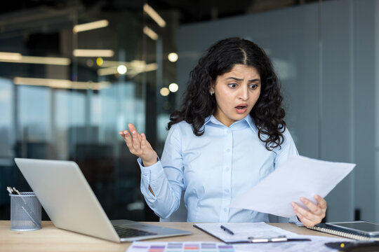 Businesswoman receiving shocking news on official document