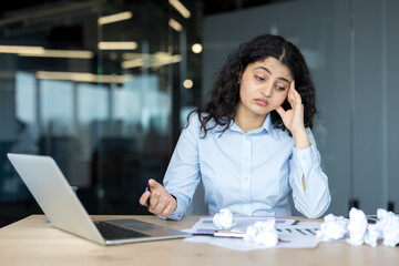 Naklejka na ściany i meble Frustrated woman experiencing stress and burnout at office workplace