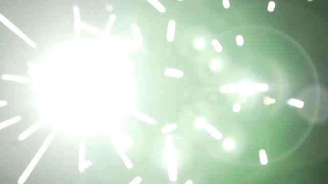Intense white strobe flashes bouncing softly off a pure chroma green backdrop leaving lingering optical blooming and soft gradient fade.