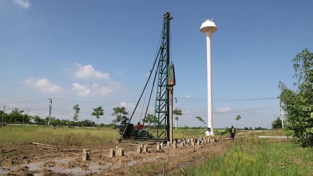 Pile Driving Rig Driving Concrete Piles at Construction Site