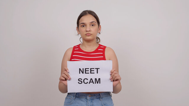 Indian Teenage Girl Holding NEET SCAM Poster