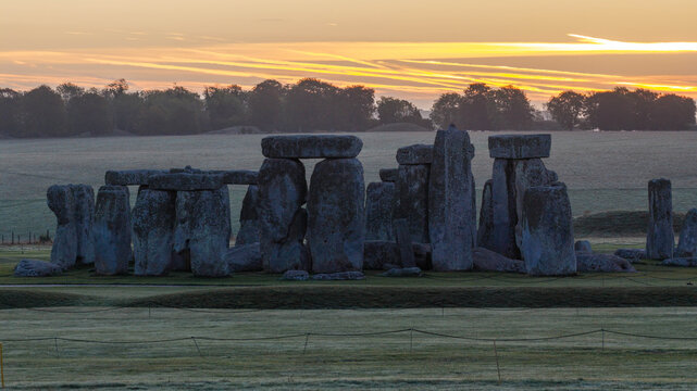 Aerial view of Stonehenge at sunrise with ancient standing stones set in the grassy landscape of Salisbury, England, United Kingdom.