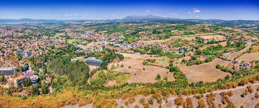 Aerial panorama of a Balkan town Sokobanja nestled between forested hills and Rtanj mountain valley - ideal for regional tourism in Serbia