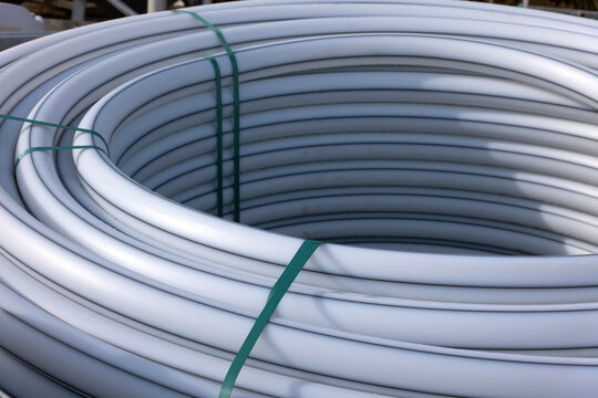 Coiled grey empty conduits for cables and utility installations