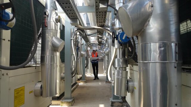 Engineer inspects cooling equipment in a facility located in the