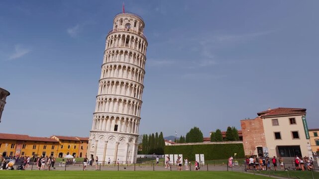 Static wide view of the Leaning Tower of Pisa with crowds of tourists on Piazza dei Miracoli in bright sunshine, Pisa, Tuscany, Italy