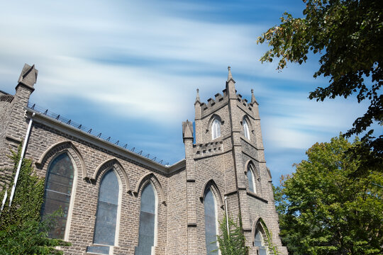 Exterior of a large stone church in a small town, stone, windows, blue skies, nobody