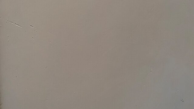 Soft blurred beige gray wall surface in gentle light