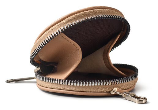 open empty beige leather coin purse isolated white background, round small wallet with metal zipper and dark interior in close-up side view