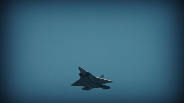 Low angle side view jet fighter gliding through clear blue sky, swept wings and metallic fuselage in open air