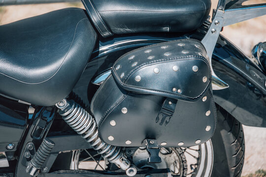 Studded leather saddlebag on a classic cruiser motorcycle - ideal for biker lifestyle and accessories concepts