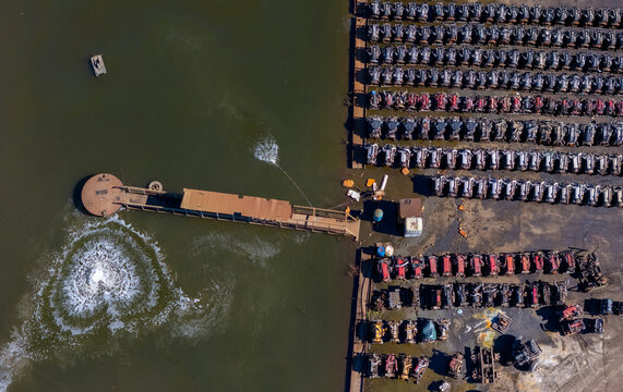 Aerial view of rows of scrapped heavy duty truck engines stored near a water treatment facility in Kalamazoo, Michigan, United States.