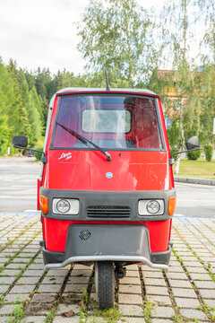 26 July 2026, Toblach, Italy. Red Piaggio Ape 50 three-wheeled utility vehicle viewed from the front