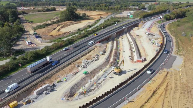 A stationary aerial view with moving traffic through the improvement roadworks at the Thickthorn Interchange in Norwich, UK