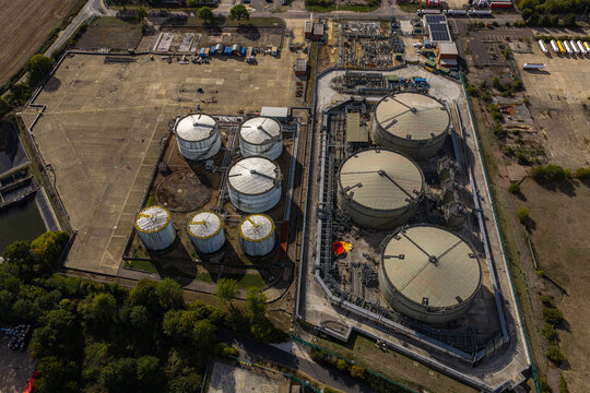 Aerial view of the Hemel Hempstead Industrial Estate featuring large storage tanks, industrial pipelines, and surrounding green space in Hemel Hempstead, England, United Kingdom.