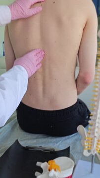 Massage therapy session focused on the back of a person in a