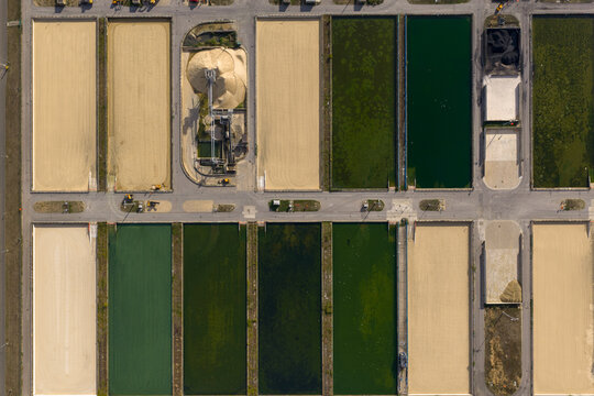 Aerial view of Ashford Common Water Treatment Works featuring rectangular filtration beds with varying water levels and industrial infrastructure in Shepperton, England, United Kingdom.
