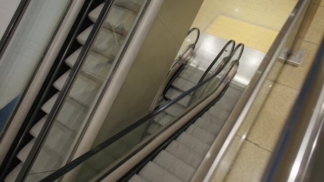 High angle view of modern empty moving escalators inside a public transit station.