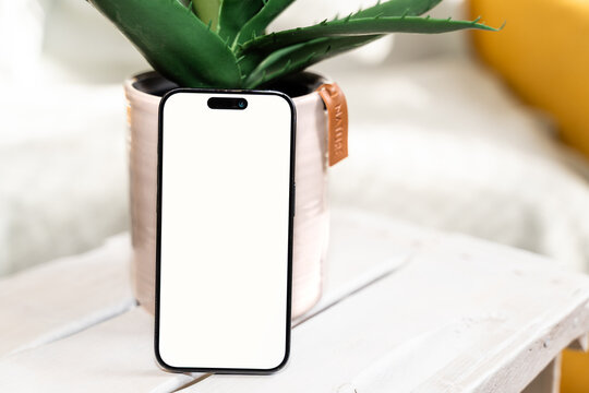 Smartphone with blank screen on white table