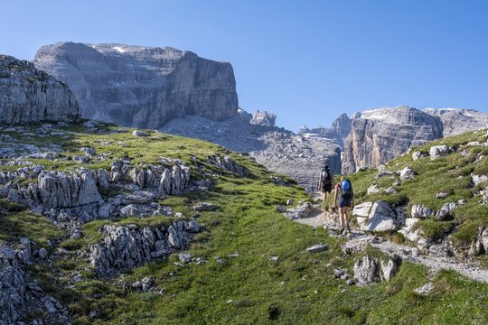 Two mountaineers on a hiking trail on the Grost&eacute; Plateau, Brenta Mountains, Parco Naturale Brenta-Adamello, Trentino, Italy