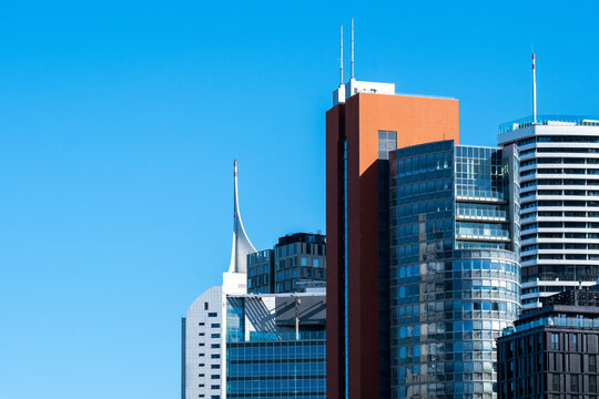 Office towers form a skyline in Donau City, Vienna, Austria, with glass facades and modern architecture creating varied vertical building forms