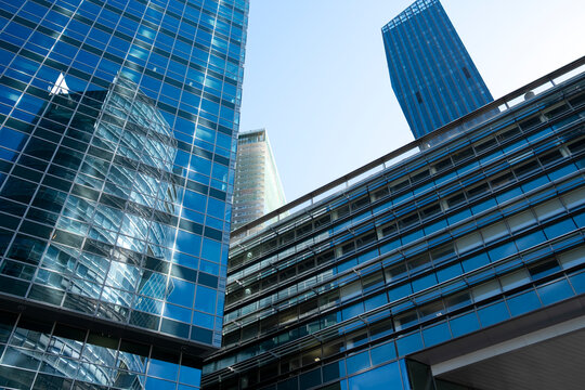 Reflective glass office buildings in Donau City, Vienna, Austria, with geometric facades and architecture intersecting across the urban frame