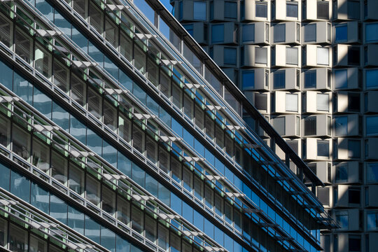 Glass office facades in Donau City, Vienna, Austria, with geometric windows and modern architecture forming a dense urban pattern across the frame