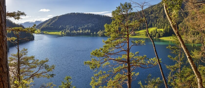 Clear blue lake surrounded by forests and mountains, Austria, Hintersteinersee, panorama