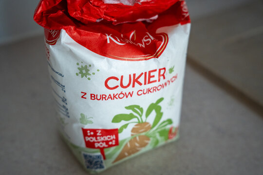 Warsaw, Poland - Sep 30, 2026: Bag of Polish beet sugar labeled Cukier z burakow cukrowych on a grey kitchen countertop, white and red packaging with sugar beet illustration and Z polskich pol badge