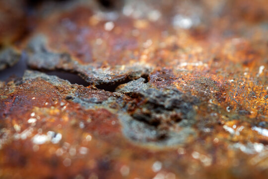 Extreme close up view of heavily rusted metal texture. Selective focus, shallow depth of field.