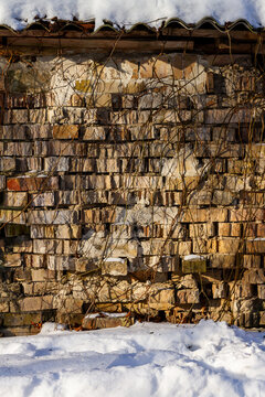 Old abandoned brick wall in winter. Architectural detail.