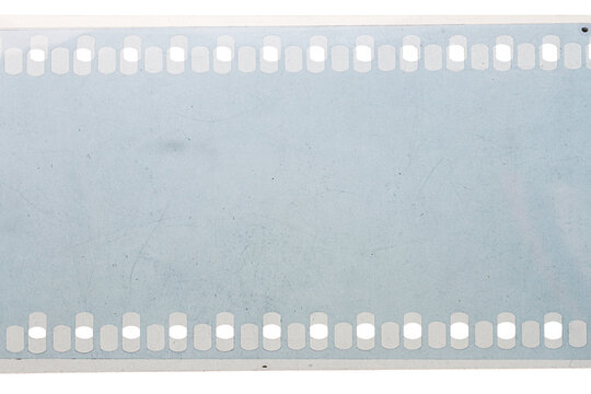 Dusty and grungy 35mm film texture or surface. Perforated scratched camera film isolated on white background.