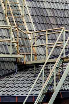 Metal staircase attached to a corrugated roof