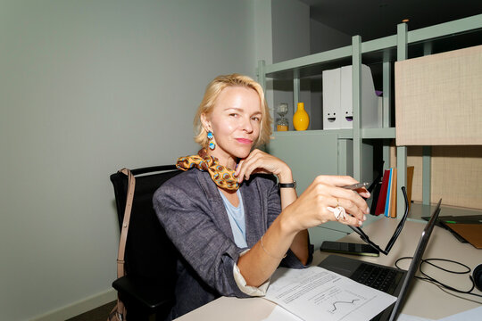 Businesswoman Working at Her Desk in Modern Office Setting