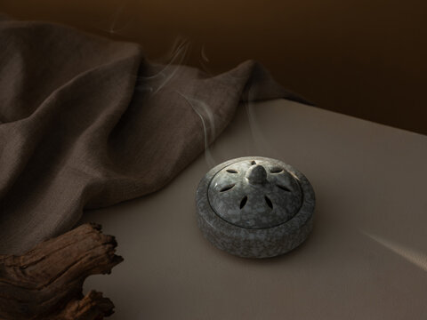 Incense Burner with Smoke against a draped fabric