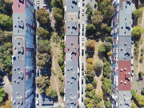 Aerial view of residential apartment blocks surrounded by trees and parked cars in a typical urban neighborhood in Sofia, Sofia City Province, Bulgaria.